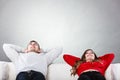 Happy couple relaxing resting on couch at home. Royalty Free Stock Photo