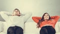 Happy couple relaxing resting on couch at home. Royalty Free Stock Photo