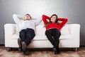 Happy couple relaxing resting on couch at home. Royalty Free Stock Photo