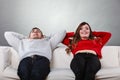 Happy couple relaxing resting on couch at home. Royalty Free Stock Photo