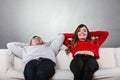 Happy couple relaxing resting on couch at home. Royalty Free Stock Photo