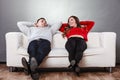 Happy couple relaxing resting on couch at home. Royalty Free Stock Photo