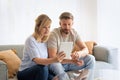 Woman and man sitting at home on the sofa and using touchpad Royalty Free Stock Photo