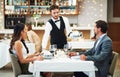 Happy couple, restaurant server and fine dining food for valentines day date, love or romance in night. Man, woman and Royalty Free Stock Photo