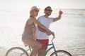 Happy couple riding bicycle at beach Royalty Free Stock Photo