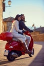 Couple riding motor scooter in city Royalty Free Stock Photo