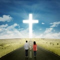 Happy couple on the road with a cross Royalty Free Stock Photo