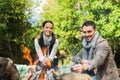 Happy couple roasting marshmallow over camp fire Royalty Free Stock Photo