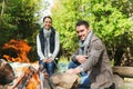 Happy couple roasting marshmallow over camp fire Royalty Free Stock Photo