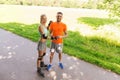 Happy couple with roller skates riding outdoors Royalty Free Stock Photo