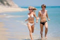 Happy couple running on beach Royalty Free Stock Photo