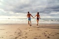 Happy Couple running on the beach, having fun on romantic honeymoon vacation Royalty Free Stock Photo