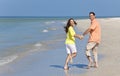 Happy Couple Running Holding Hands on A Beach Royalty Free Stock Photo