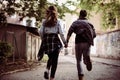 Happy couple running outdoor and holding hands. Royalty Free Stock Photo