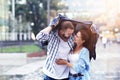 Happy couple running in the rain in the city Royalty Free Stock Photo