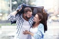 Happy couple running in the rain in the city Royalty Free Stock Photo