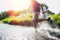 Happy couple running in shallow water