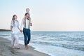 Happy couple on sea beach at resort. Walking along the sea shore. Family vacation concept Royalty Free Stock Photo