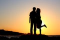 Happy couple by the sea silhouette