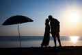 A Happy couple by the sea at sunset on travel silhouette in nature Royalty Free Stock Photo