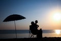 A Happy couple by the sea at sunset on travel silhouette in nature Royalty Free Stock Photo