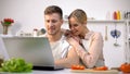 Happy couple searching delicious recipe in internet, food blog browsing