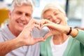 Happy couple, senior or heart hands in home for love, support or bonding in retirement together. Romance blur, hand