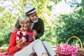 Couple senior man surprise giving gift box to his wife while relaxing in the park Royalty Free Stock Photo