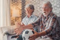 Happy couple of seniors or football fans watching soccer on tv and frustrating and getting mad at home. Family, sports and