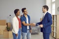 Happy couple shaking hands with a real estate agent after buying a new apartment Royalty Free Stock Photo