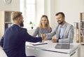 Happy couple shaking hands with real estate agent after signing contract at his office Royalty Free Stock Photo