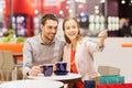 Happy couple with shopping bags drinking coffee Royalty Free Stock Photo