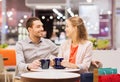 Happy couple with shopping bags drinking coffee Royalty Free Stock Photo