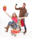 Happy couple with shopping cart of Christmas presents Royalty Free Stock Photo