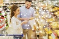 Happy couple with shopping cart at grocery store Royalty Free Stock Photo