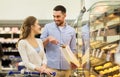 Happy couple with shopping cart at grocery store Royalty Free Stock Photo