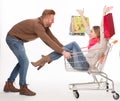 Happy couple with shopping cart Royalty Free Stock Photo