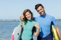 happy couple showing surf signs Royalty Free Stock Photo