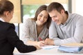 Happy couple signing a contract at office Royalty Free Stock Photo