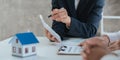 Happy couple signing a contract with real estate agent. renters tenants sign mortgage loan investment agreement or Royalty Free Stock Photo