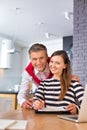 Happy couple signing contract at table in apartment Royalty Free Stock Photo