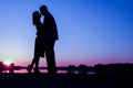 Happy couple silhouette against a sunset romance Royalty Free Stock Photo