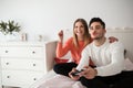 Happy couple sitting on bed playing video games Royalty Free Stock Photo