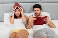 Happy Couple Sitting in Bed Reading Books at Home in Bedroom Royalty Free Stock Photo