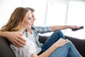 Happy couple sitting on couch and watching tv Royalty Free Stock Photo