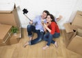 Happy couple sitting on floor celebrating champagne toast moving Royalty Free Stock Photo