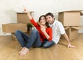 Happy couple sitting on floor celebrating moving in new flat house or apartment Royalty Free Stock Photo