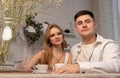 Happy couple sitting at kitchen portrait. Beautiful woman and handsome man drinking tea or coffee. Tender relations Royalty Free Stock Photo