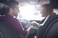 Happy couple sitting in a new car. Girlfriend giving car keys to Royalty Free Stock Photo