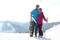 Happy couple with ski equipment spending winter vacation in mountains Royalty Free Stock Photo